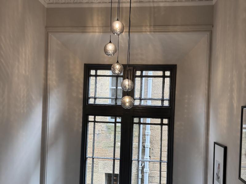 Cluster of glass pendant lights in a tall stairwell
