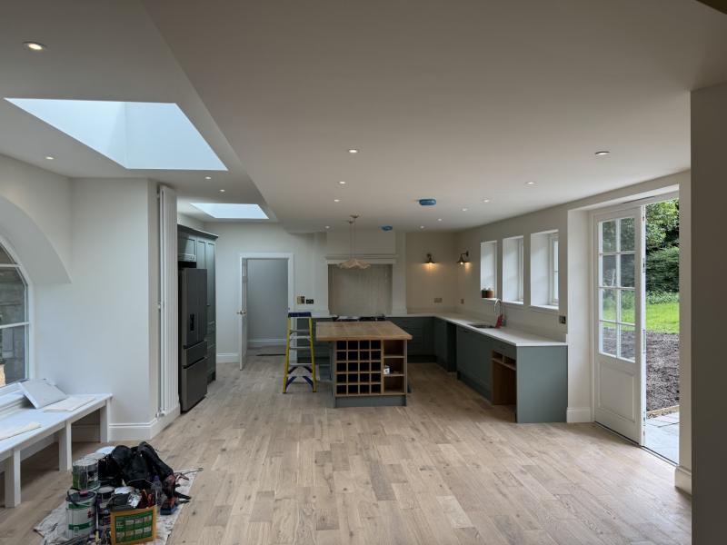 Open-plan kitchen renovation with roof lights and downlights
